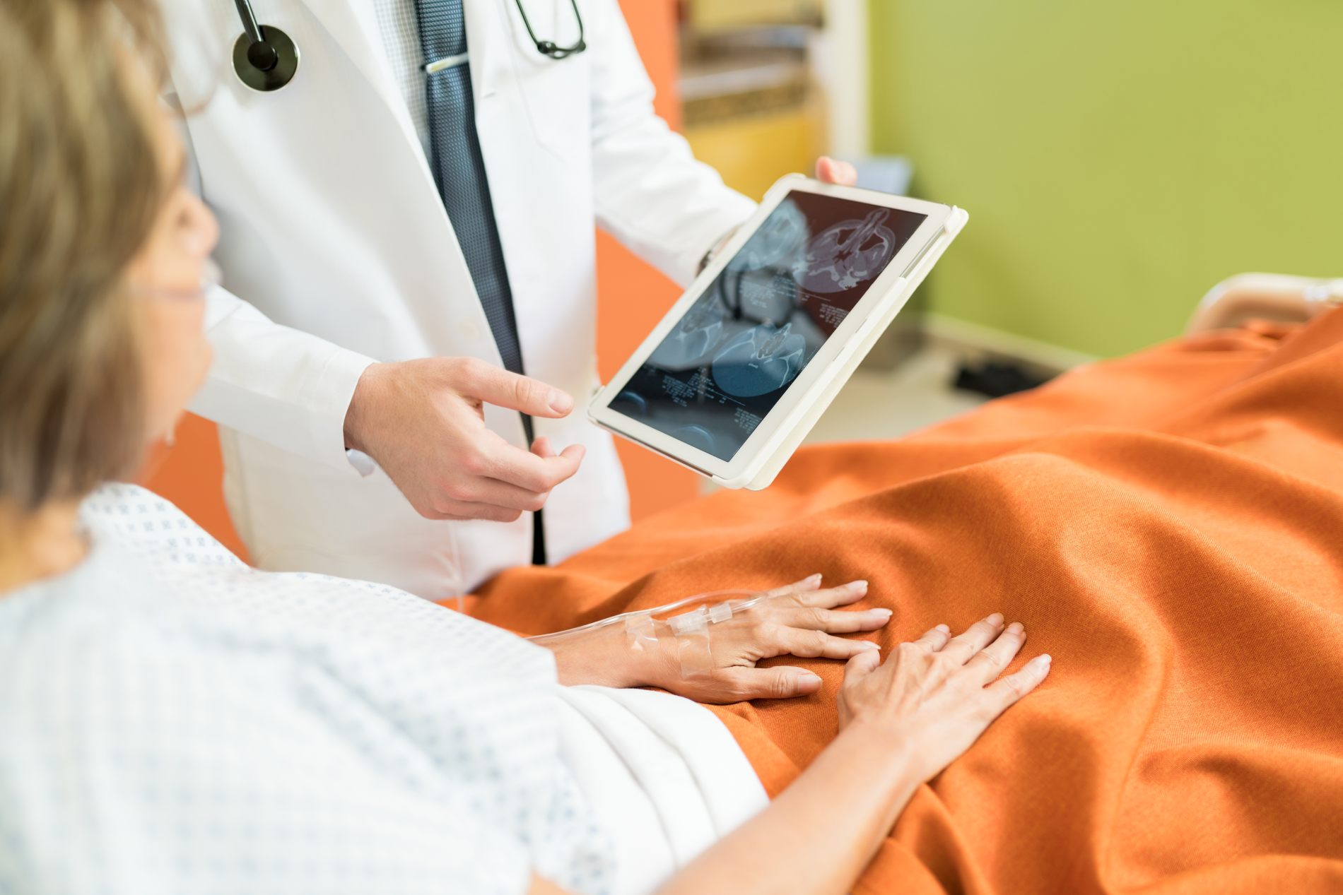midsection-doctor-showing-xray-report-digital-tablet-senior-patient-hospital
